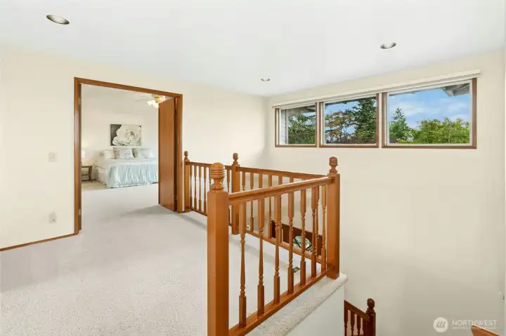 Landing upstairs overlooks grand 2 story entry and wide stairway.