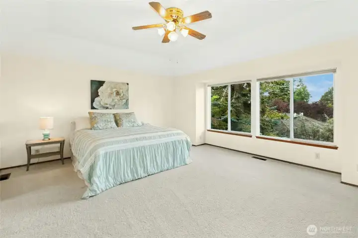 Oversized primary suite with territorial views and dual closets.