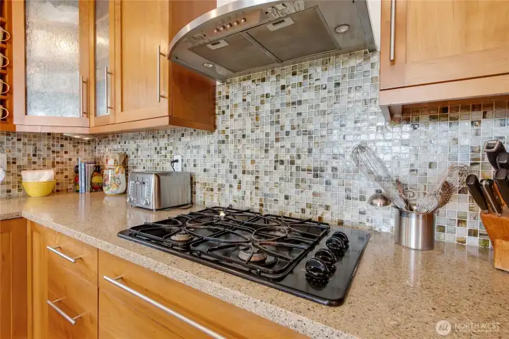 Mosaic tile backsplash is perfect accent to this amazing kitchen.