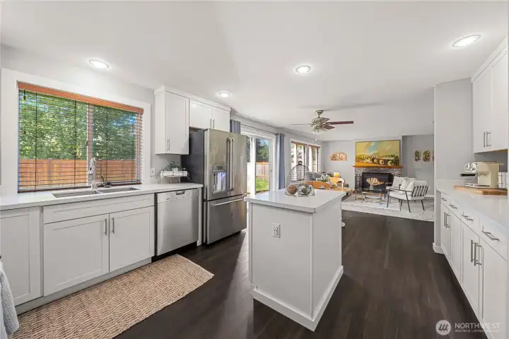 Fully remodeled kitchen with quartz countertops and stainless appliances.