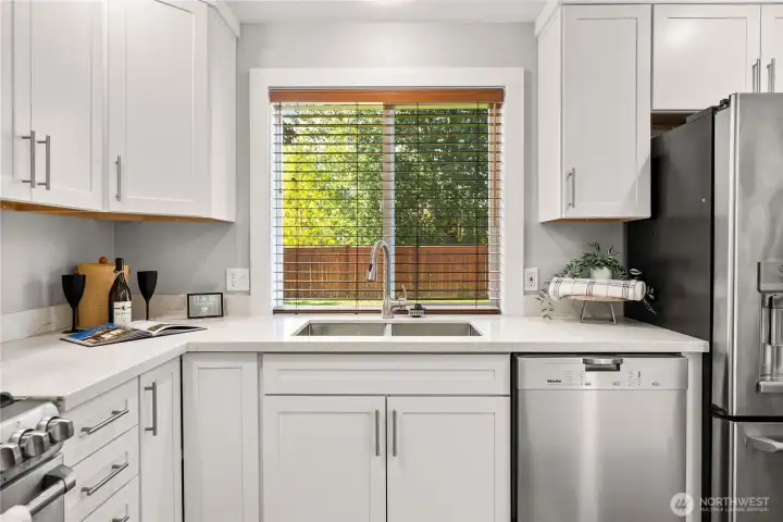 Picturesque window overlooking the fully fenced backyard.