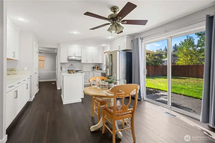 Breakfast nook off kitchen, sliding glass door leading to leveled backyard.