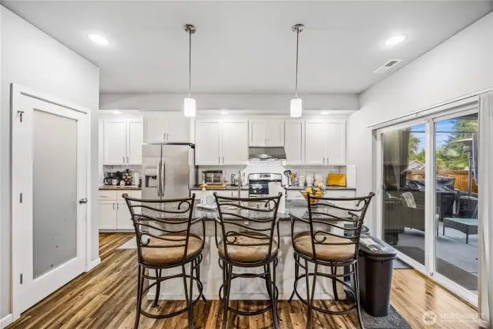 Bright kitchen layout with open flow to dining and patio access