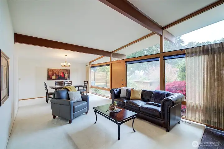 Dining room and living room feature floor to ceiling windows that bring in lots of natural light.