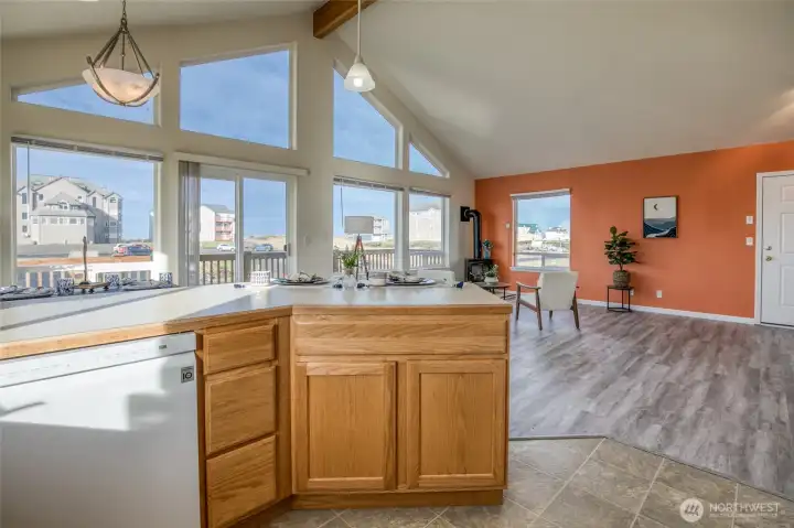 Kitchen is open to the West facing wall of windows