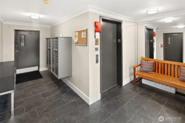 Secure lobby with elevator access, nearby stairwell (just to the left), and a direct interior door to the covered, gated garage - makes coming and going both easy and protected.