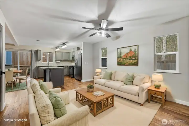 The open floor plan provides exceptional flexibility, with living and dining areas that can be arranged in a variety of ways to suit your personal style and needs. (Virtually staged)