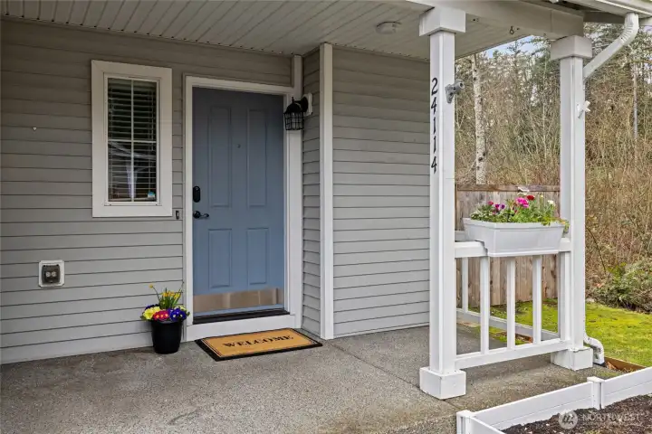 Covered front porch for seasonal decor or quiet morning coffee.