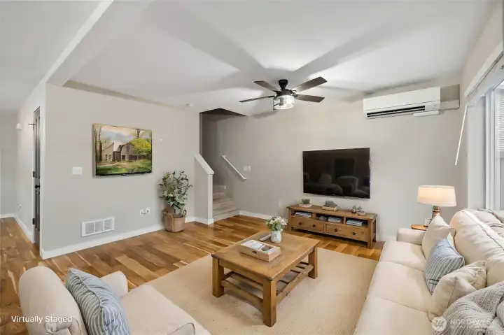 The open floor plan provides exceptional flexibility, with living and dining areas that can be arranged in a variety of ways to suit your personal style and needs. (Virtually staged)