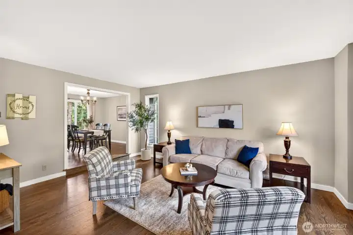 Rich updated hardwood floors anchor the spacious living room, which connects seamlessly to the formal dining area — an ideal layout for both everyday living and effortless entertaining.