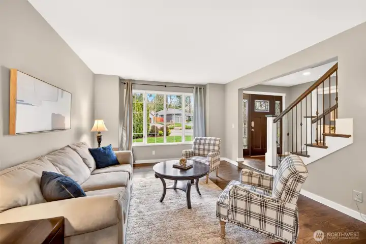 Oversized windows flood the living room with natural light while framing a peaceful, leafy outlook — a bright, welcoming retreat just minutes from Microsoft, Google, and major Eastside tech corridors.