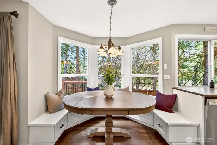 The charming built-in breakfast nook with bay windows brings the beauty of the surrounding tree canopy indoors — a warm, light-filled spot perfectly suited for morning coffee or a relaxed weekend brunch.