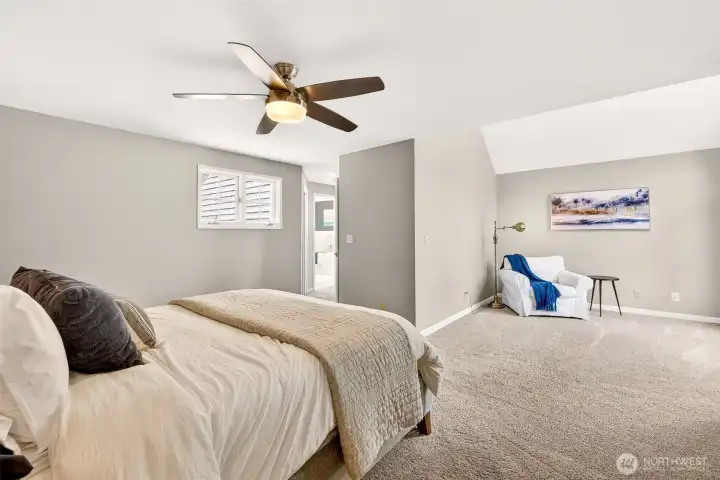 The spacious primary bedroom offers room to truly unwind — with plush carpet, a ceiling fan, plantation shutters, and a private ensuite just steps away, this is a retreat designed for everyday comfort.