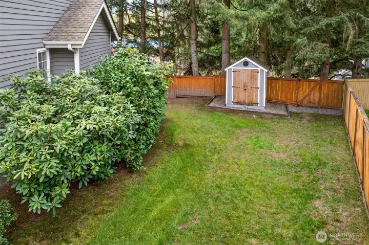 A detached storage shed tucked into the corner of the fenced backyard offers convenient extra storage for tools, outdoor equipment, or garden supplies — a practical bonus on an already generous 11,257 SF lot.