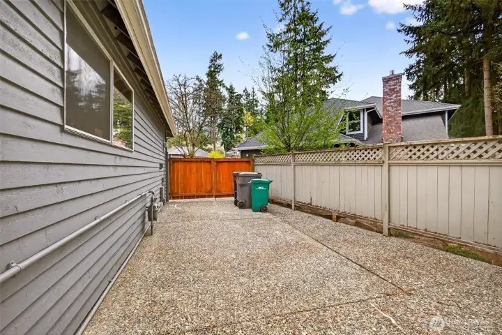 A gated side yard passage provides secure, convenient access around the home — a practical feature for outdoor storage, pet containment, or utility access, all neatly tucked behind the fence line.