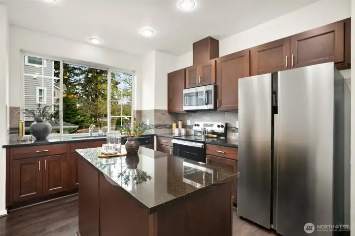 Rich cabinetry and stainless appliances, including a new refrigerator and range.