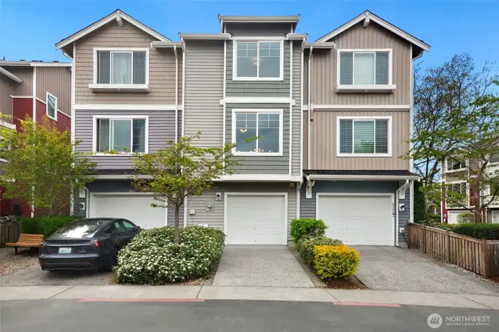 Attached garage with additional driveway parking and a clean, well-maintained exterior.