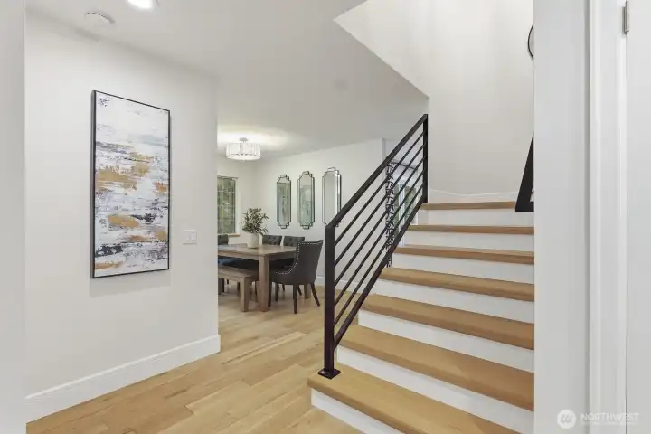 Wide plank hardwood floors throughout the home and new iron railing.