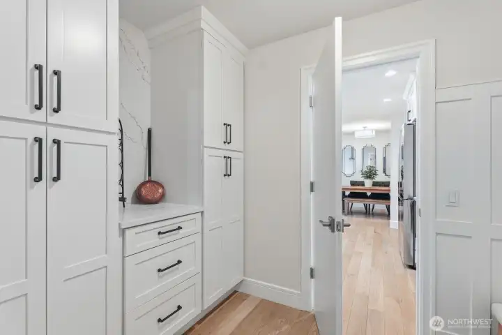 The mud room off the kitchen features custom built-in cabinetry and the entrance to the 3 car garage.