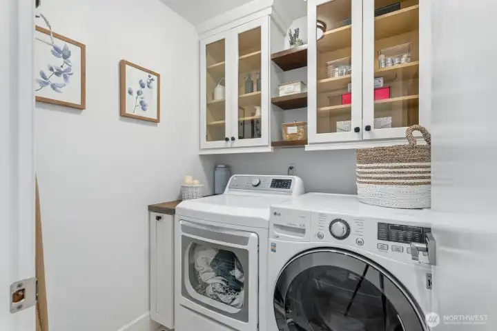 Updated laundry room with newer LG washer & dryer and attractive cabinetry.