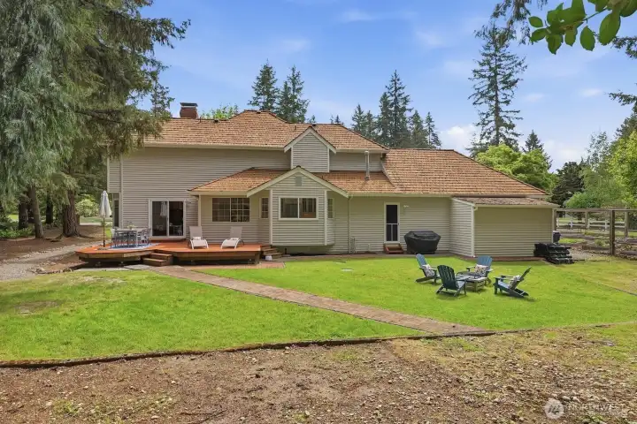The beautifully private backyard features an entertaining Ipe deck and deer proof irrigated raised garden beds and a protected creek behind the property!