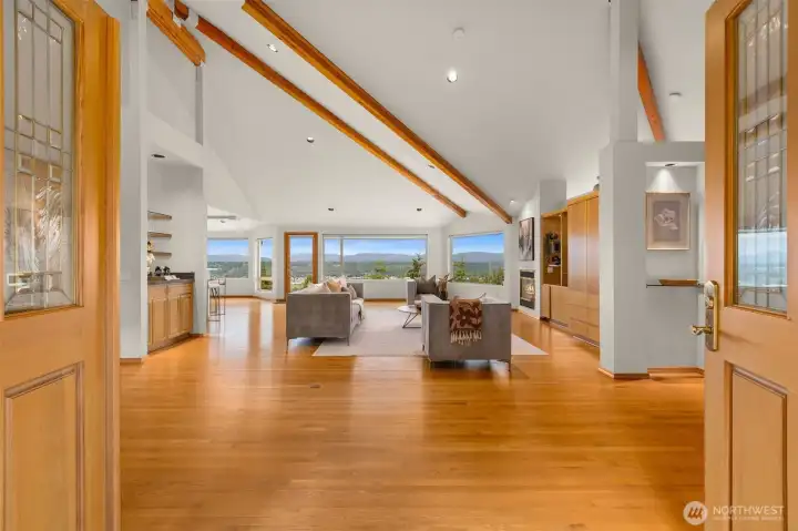 The main floor welcomes you with vaulted ceilings, beautiful exposed wood beams, expansive living spaces, and walls of custom windows that frame breathtaking postcard-worthy mountain and valley views
