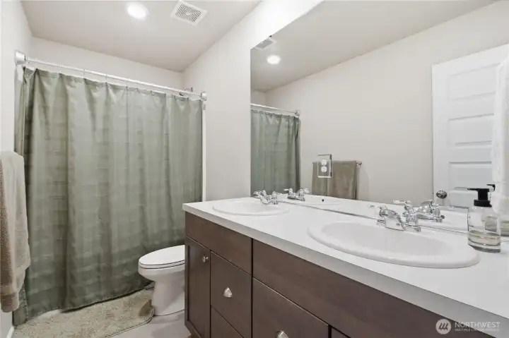 This large bathroom serves the upstairs bedrooms with double sink vanity, full tub and shower and lots of storage. This large bathroom serves the upstairs bedrooms with double sink vanity, full tub and shower and lots of storage.