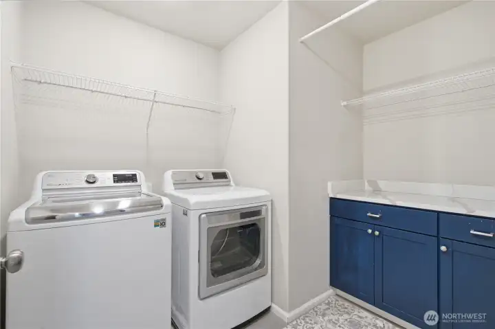 The laundry room is located near the bedrooms for convenience. Shelving, hanging rod and pretty storage cabinet with generous counter top space for folding. The laundry room is located near the bedrooms for convenience. Shelving, hanging rod and pretty storage cabinet with generous counter top space for folding.