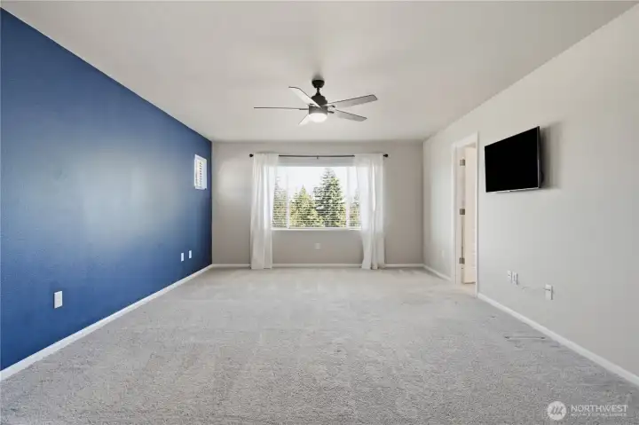 This large Primary bedroom could accommodate any number of furniture arrangements or styles. The designer accent wall picks up the theme from below. The large window brings in natural light and peaceful view. The door leads to the ensuite bath. This large Primary bedroom could accommodate any number of furniture arrangements or styles. The designer accent wall picks up the theme from below. The large window brings in natural light and peaceful view. The door leads to the ensuite bath.