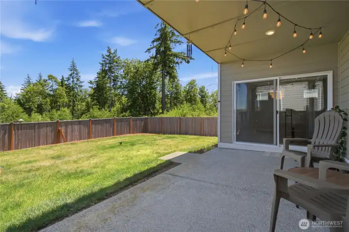 At the end of the day, relax and enjoy the covered patio and view of the backyard, extending beyond to open sky and forest. At the end of the day, relax and enjoy the covered patio and view of the backyard, extending beyond to open sky and forest.
