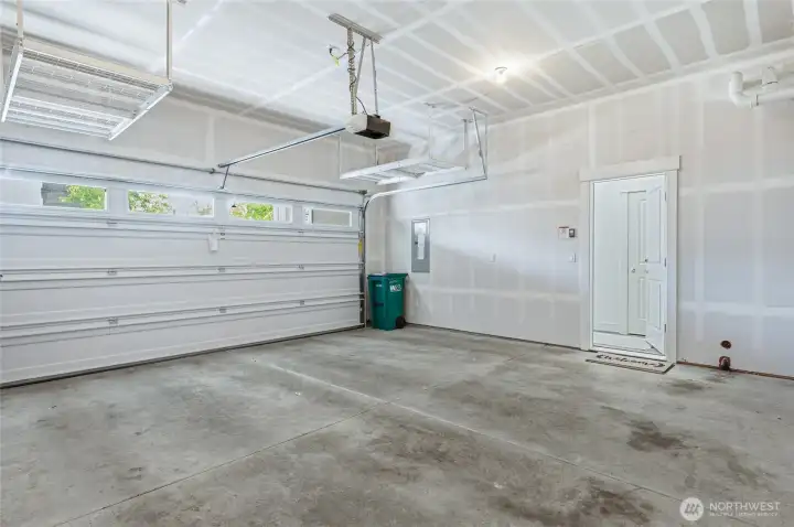 Two car garage with overhead storage to maximize space.