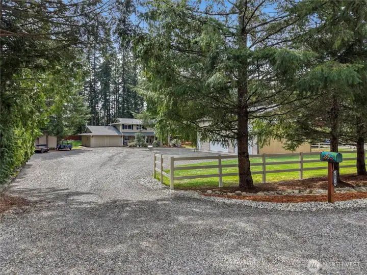 Nestled on a landscaped 1 acre lot this property offers privacy and convenience! Bring all your recreational toys for there is TONS of parking.