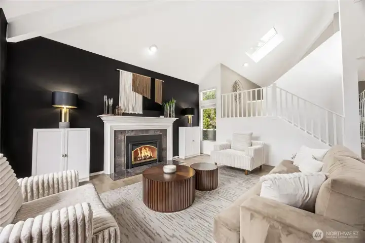 Alternative view of the expansive main living area, highlighting the brilliant open-concept flow, continuous luxury flooring, and a bold, contemporary matte-black accent wall