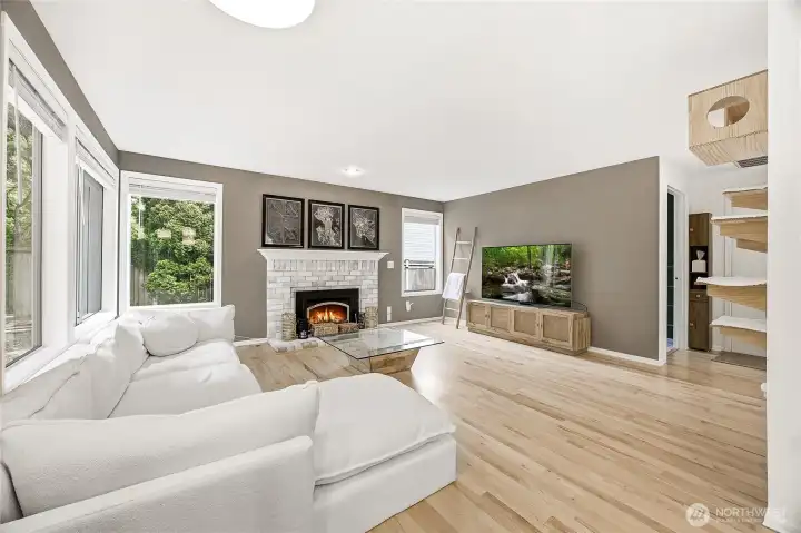 Another stunning perspective of the expansive main floor family room, highlighting the bright, airy open-concept footprint and continuous premium wide-plank flooring. Entirely carpet-free for a sleek, low-maintenance finish