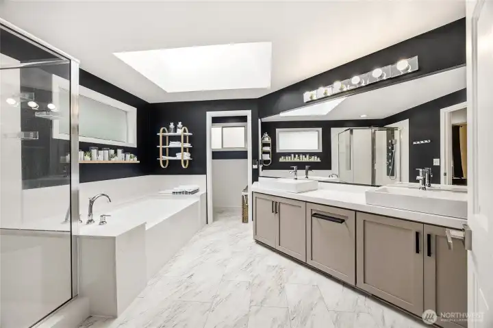 Spa-like primary bathroom remodel complete with a custom double vanity, sleek integrated mirror lighting, updated fixtures, and contemporary design accents.