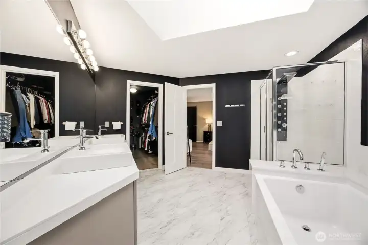 Detailed view of the primary bathroom’s custom walk-in shower, highlighting the high-end designer tile surround, built-in storage niche, and sleek modern fixtures that create a true spa-like experience.