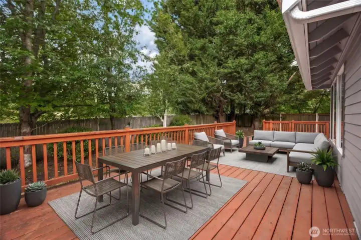Virtually staged expansive back deck, illustrating the ultimate outdoor entertainment layout for summer barbecues, alfresco dining, and peaceful morning coffee.
