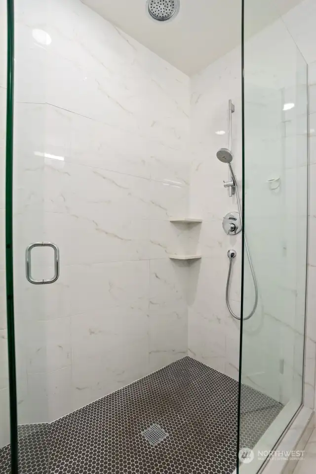 A sleek and sophisticated walk-in shower in the primary bath is certain to be a fan favorite.