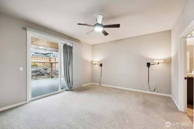 Primary bedroom with sliding glass door out to your covered patio