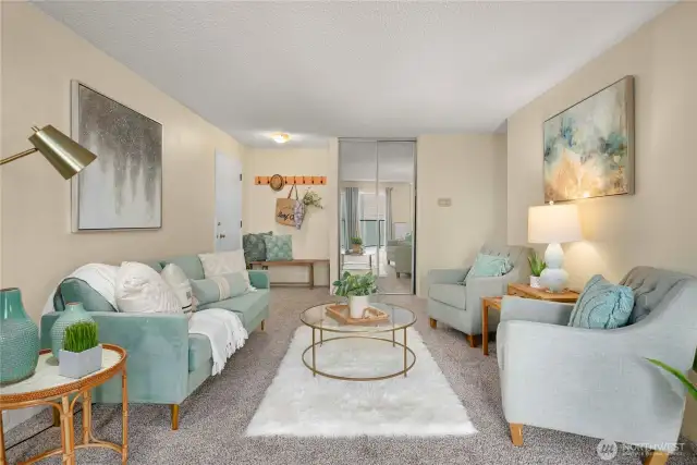Spacious living area is bathed in natural light, creating a warm and inviting atmosphere.