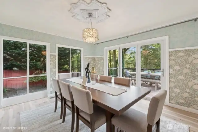 Dining room with folding doors to deck that runs the length of the home.