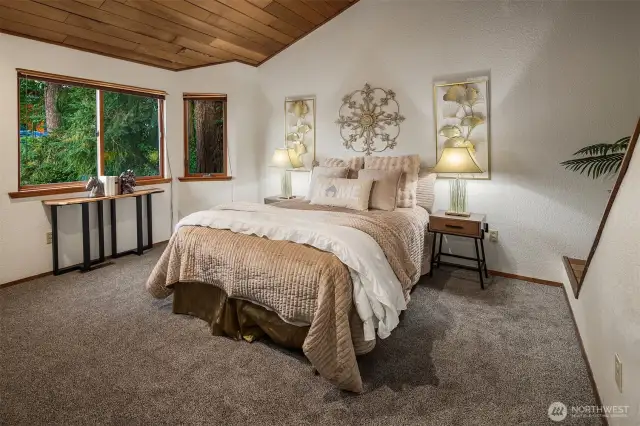 The primary bedroom enjoys high ceilings and lots of natural light.