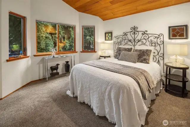 The second of three bedrooms upstairs with private and lush views.