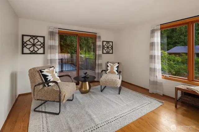 The living room has a slider that transitions to the spacious new deck area.