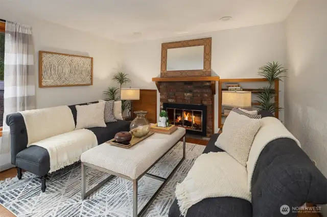 The main level dining room with cozy wood burning fireplace.
