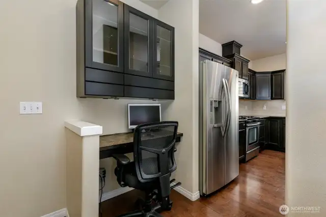 Desk and partial view of kitchen