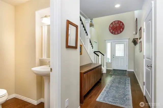 Entry, stairs going to upper level and ½ bath