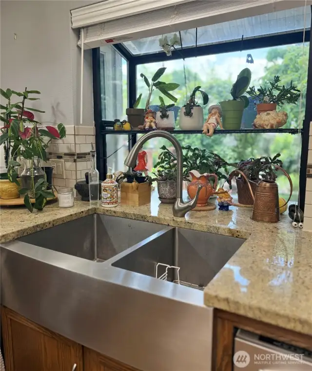 Kitchen window box overlooking the lush garden space