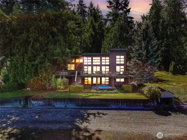 Experience coastal living at its finest in this stunning NW Contemporary on Johnson Point! Enjoy sweeping Puget Sound views with Harstine Island to the south, Longbranch to the north, and breathtaking sunsets over the Olympic Range through a wall of west-facing custom wood windows. Over 4,000 SF of living space with main-floor primary suite, gourmet kitchen, expansive great room, and 1,000 SF deck capable of entertaining 50+ guests. Downstairs offers a large rec space, guest suite, ¾ bath, and direct access to the swim spa and patio. Detached oversized 2-car garage features a 600+ SF guest loft with its own ¾ bath -perfect for Airbnb/VRBO. Just 8 steps to a walkable beach with full Mt. Rainier view—this is true Northwest luxury!