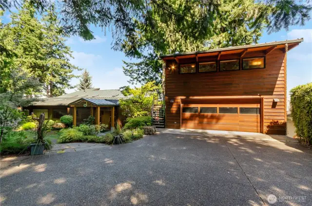 No maintenance front yard has artificial grass on east side of home. Detached garage has exterior stair case to studio space